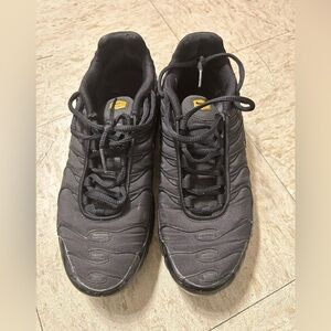 Black and gold Nike shoes